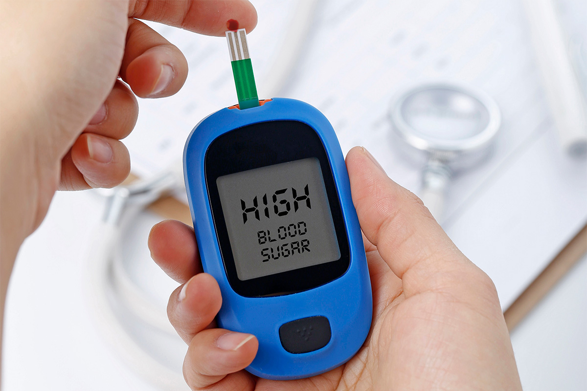 Blood sugar tester displaying glucose reading