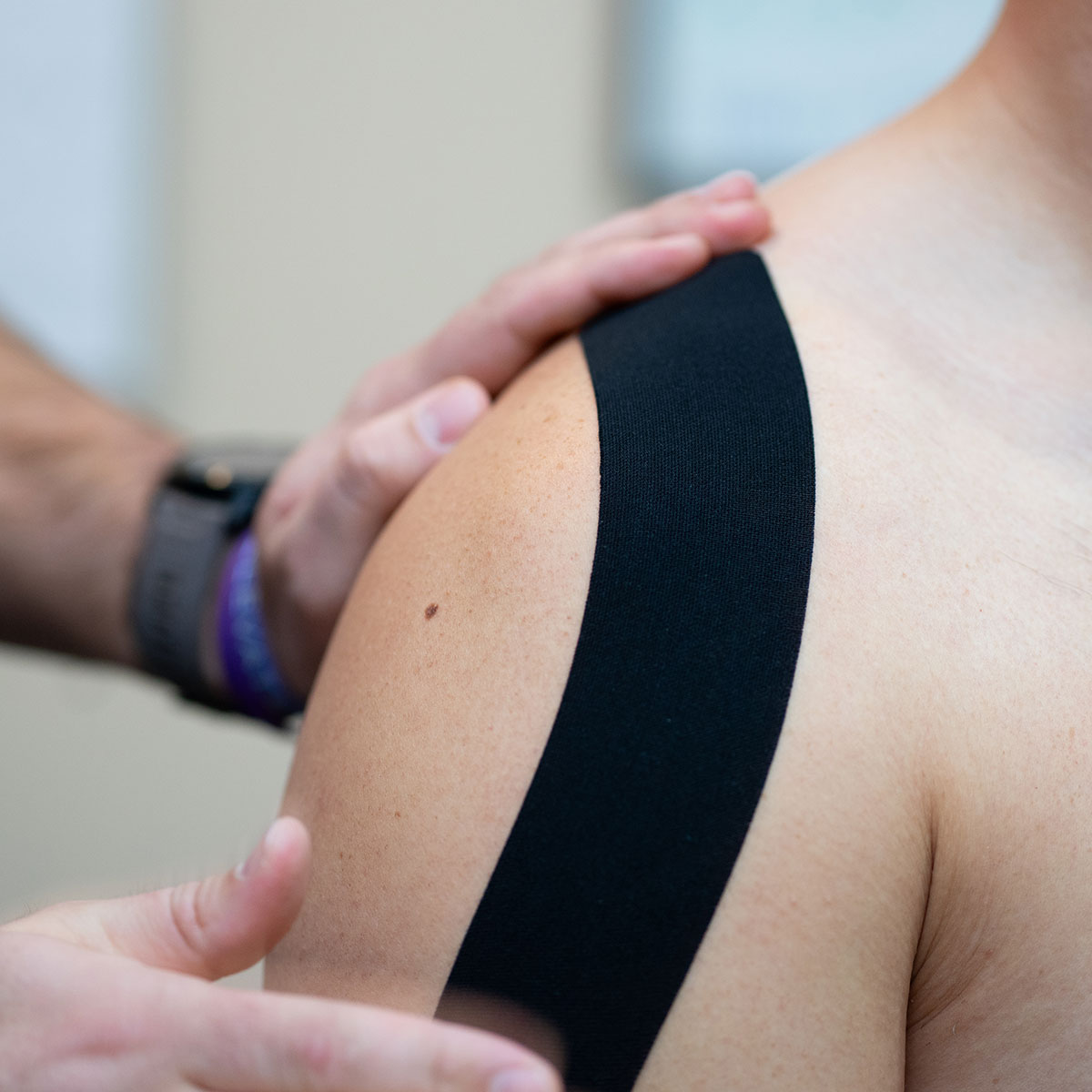 Doctor using RockTape on patient